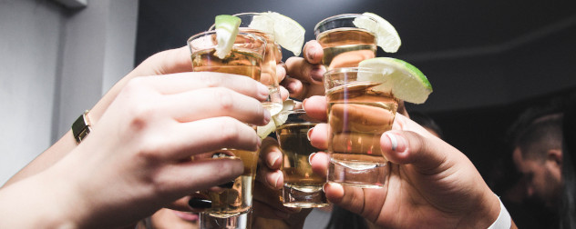 people toasting with shot glasses, detail.