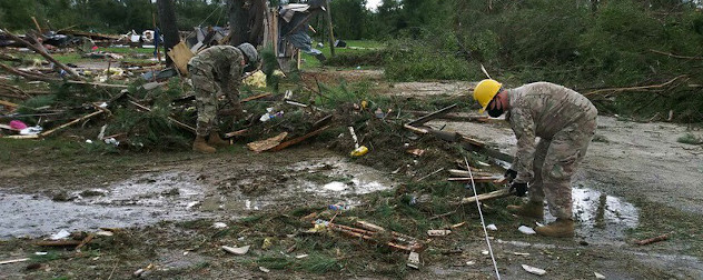 Members of the North Carolina National Guard pick through post-hurricane debris.