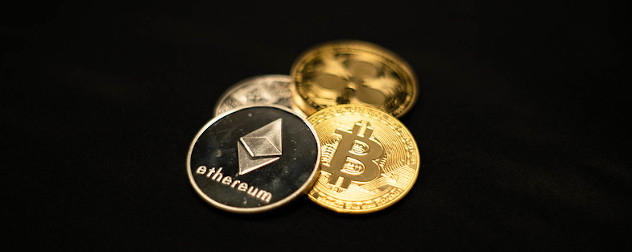 physical tokens representing various cryptocurrencies, including Ethereum and Bitcoin.