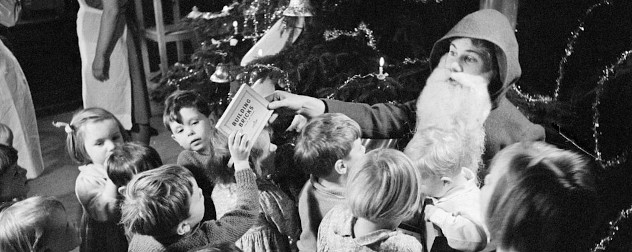 Father Christmas hands out toys at a home for evacuees, Henley-on-Thames, Oxfordshire, December 1941.