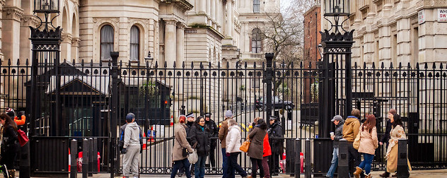 pedestrian traffic outside the gate the provides security to London's Downing Street.