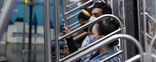 masked mass transit riders on a New York City subway car.