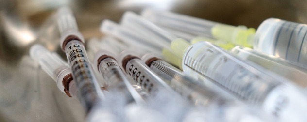 piled syringes, like those used to administer a vaccine.