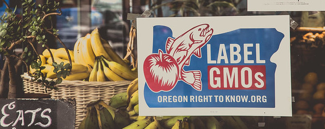 a sign promoting labeling GMOs in the window at Proper Eats, a vegan restaurant in North Portland, Oregon.