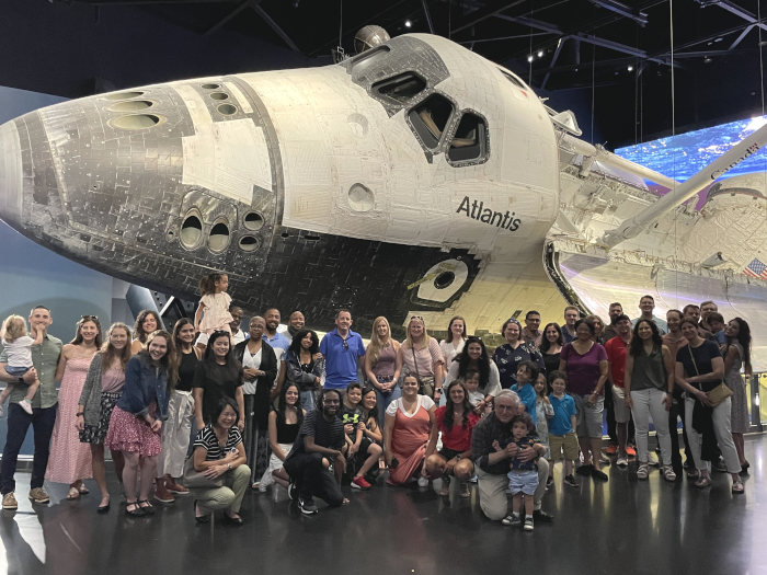 Palisades Hudson staff and family in front of the Space Shuttle Atlantis at the Kennedy Space Center.