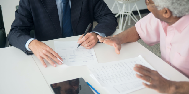 elderly person consulting with an insurance agent (detail)