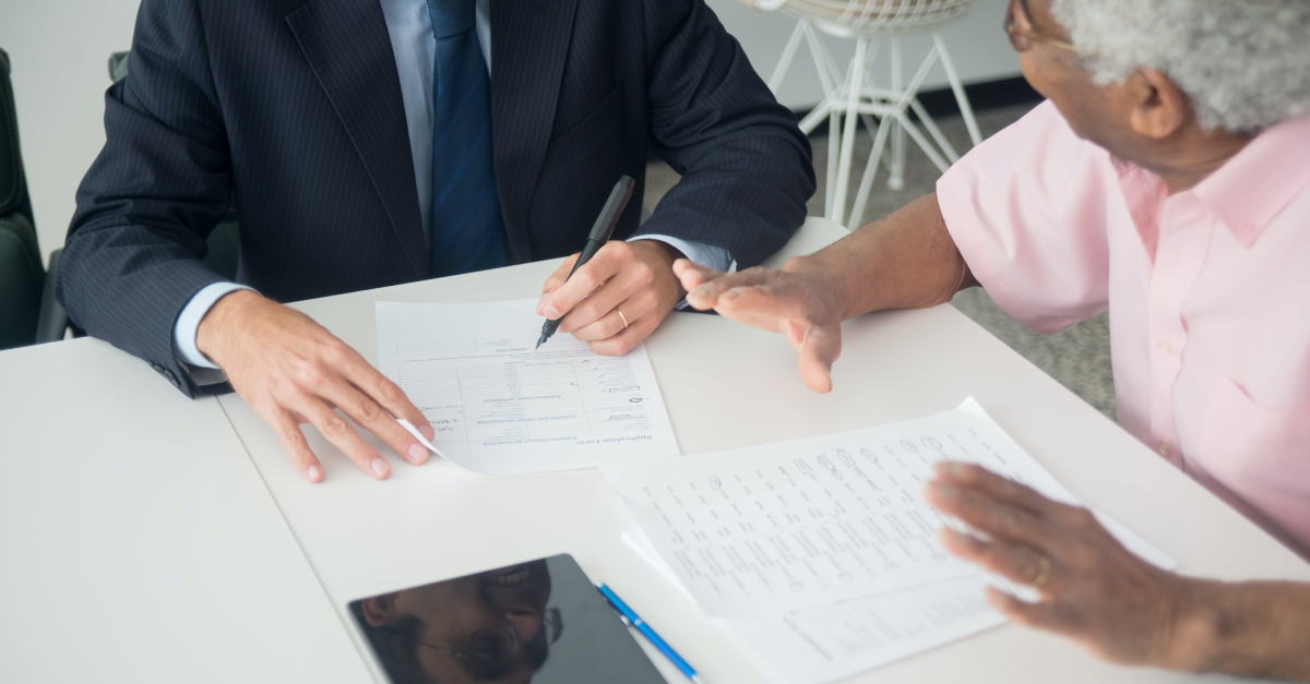 person consulting an insurance agent, detail of hands.