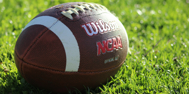 close-up of a Wilson football with the NCAA logo.